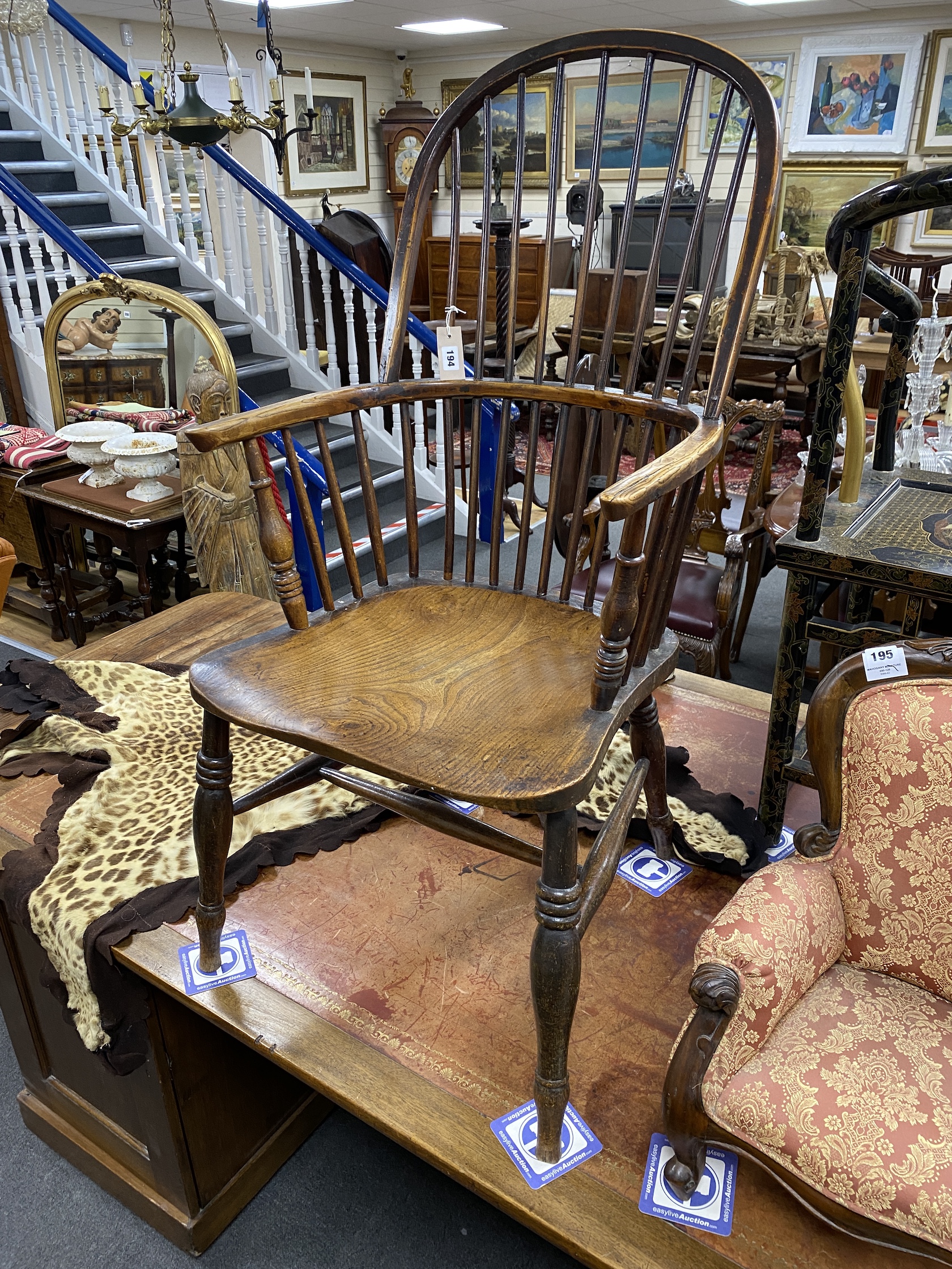 An early 19th century Windsor elm and beech comb back armchair, width 51cm, depth 49cm, height 114cm